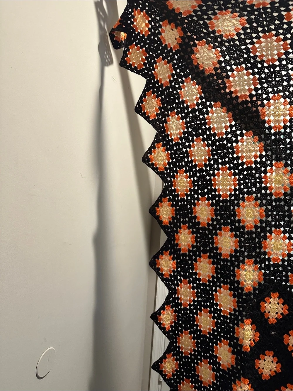 Granny Square black with orange crochet blanket with zig zag hem